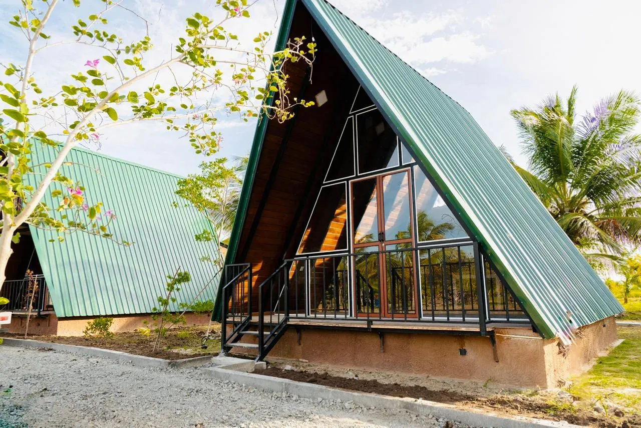 Green-roof A-frame villas in a tropical setting