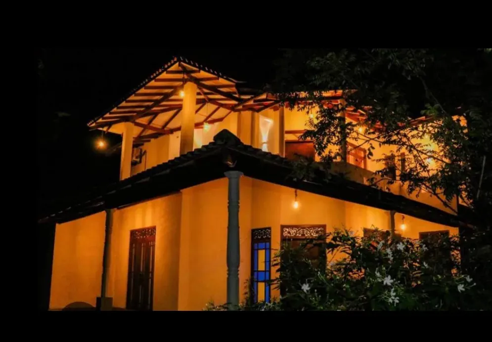 Warm lit villa exterior at night